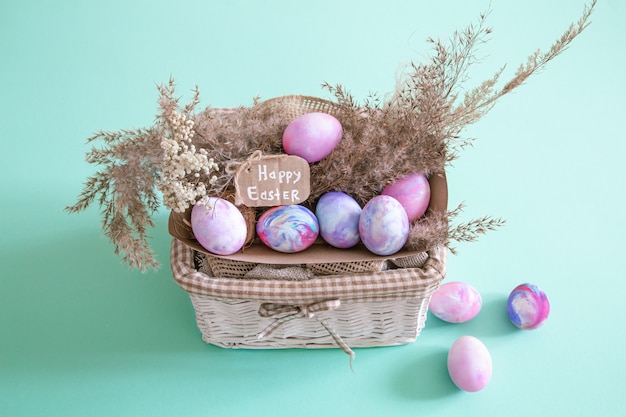 Free photo basket with easter eggs on a colored isolated background.