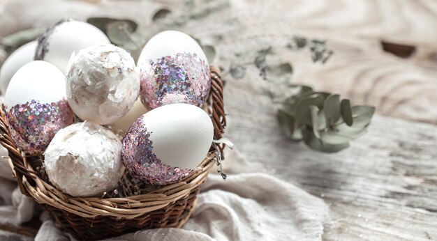 Basket with eggs and dried flowers. An original idea for decorating Easter eggs.