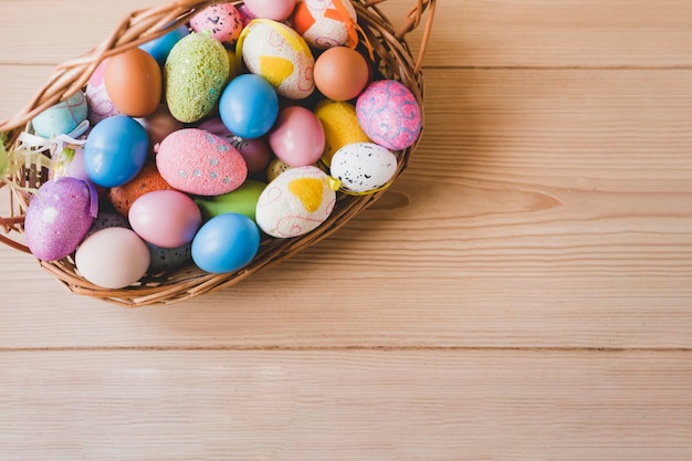 Basket with eggs on wooden tabletops