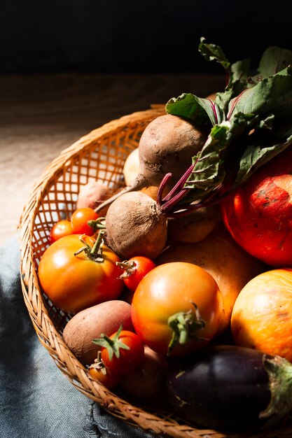 Basket with radishes and unripe tomatoes