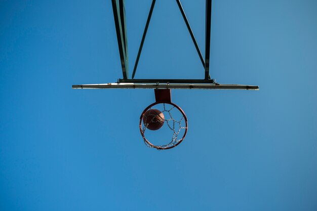 Basketball going through hoop low angle