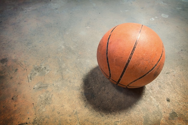 Basketball on grunge concrete floor