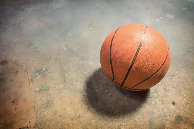 Basketball on grunge concrete floor