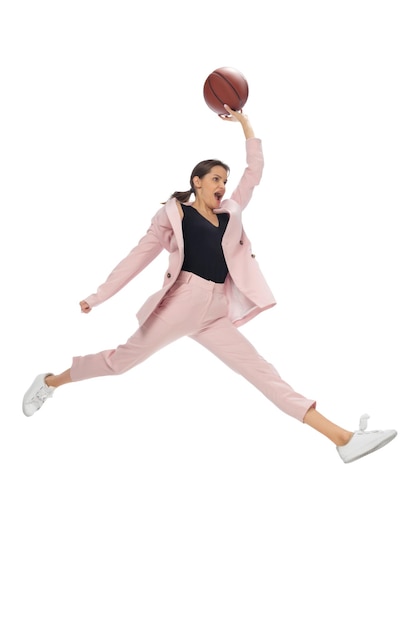 Basketball. Happy young woman dancing in casual clothes or suit, remaking legendary moves and dances of celebrity from culture history. Isolated. Action, motion, fame concept. Creative occupation.