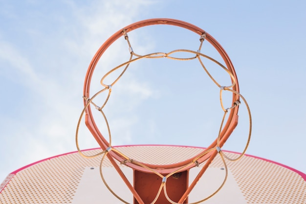 Basketball hoop against blue sky