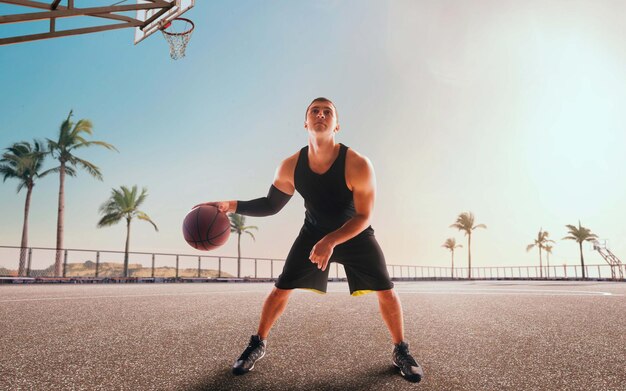 Basketball player in action on sunset