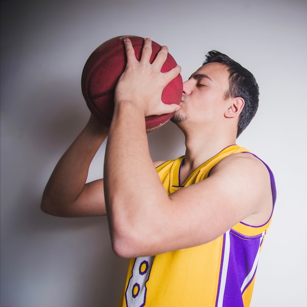 Free photo basketball player kissing ball