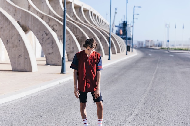 Free photo basketball player standing on street