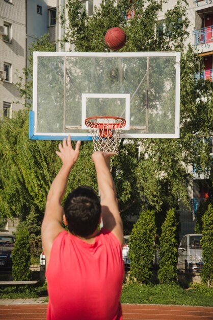 Basketball player throwing towards backboard