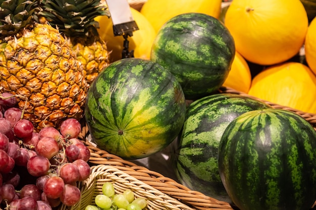 Free photo baskets with exotic fruits on a supermarket showcase