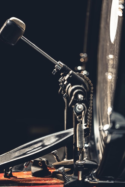 Bass drum with pedal musical instrument on black background