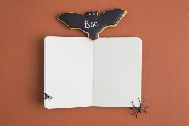 Bat gingerbread near opened notebook