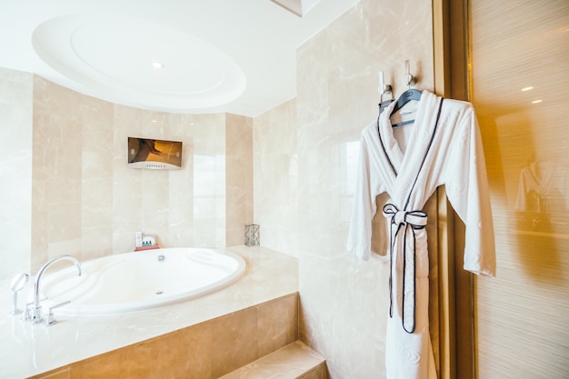 Bathrobe next to a modern bathtub