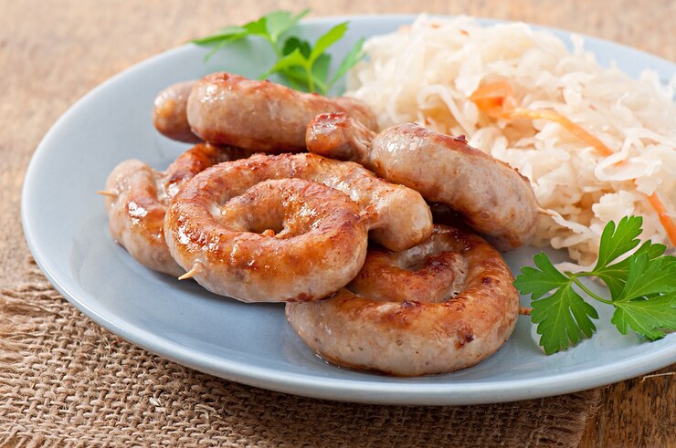 Free Photo bavarian fried sausages on sauerkraut