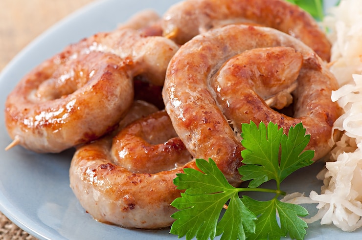 Free Photo bavarian fried sausages on sauerkraut