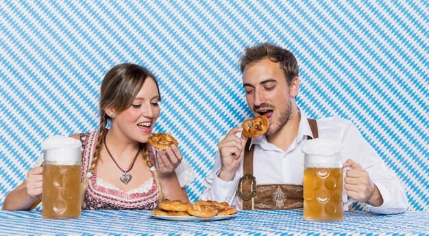 Bavarian friends tasting oktoberfest snacks