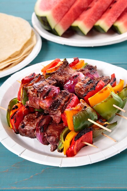 Bbq skewer with beef and vegetables on picnic table