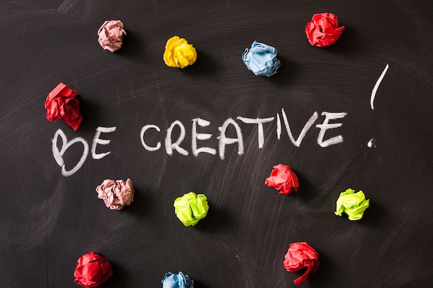 Be creativity word with colorful crumpled paper ball on blackboard