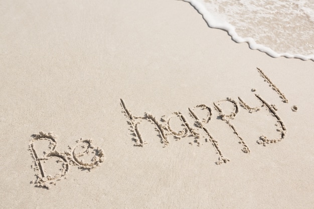 Be happy written on sand