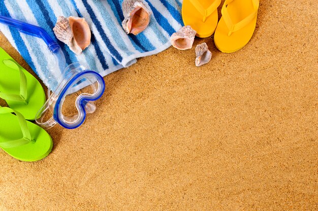Beach background with scuba mask and flip flops