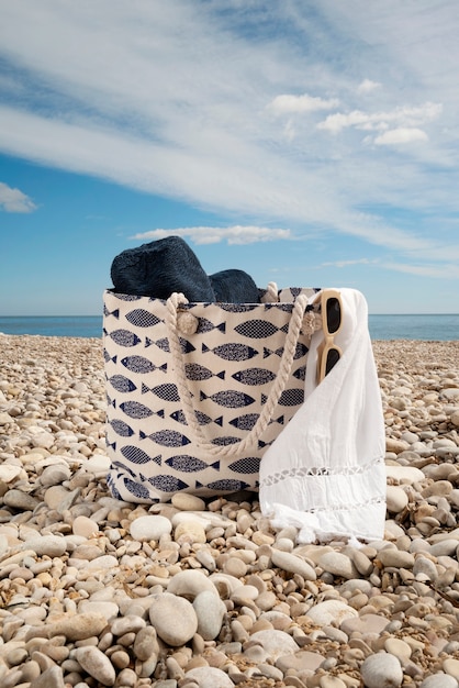 Beach bag with essentials still life