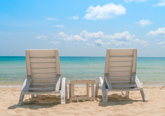 Beach chairs on tropical white sand beach