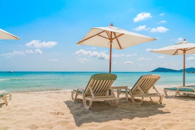 Beach chairs on tropical white sand beach