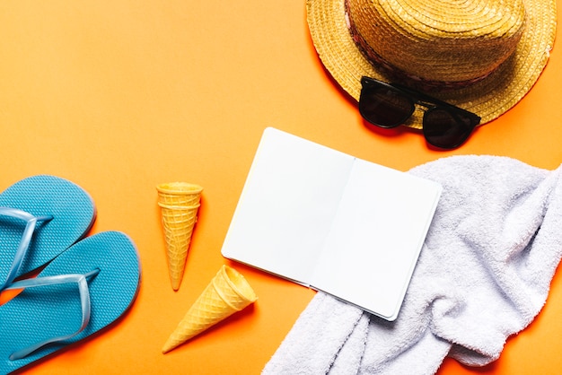 Beach composition with notebook on bright background