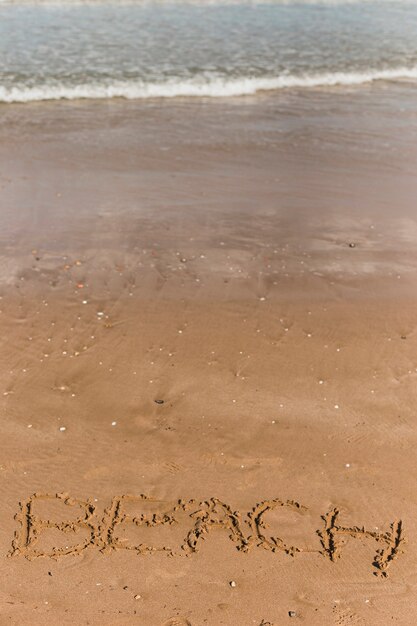 Beach concept with letters written in sand