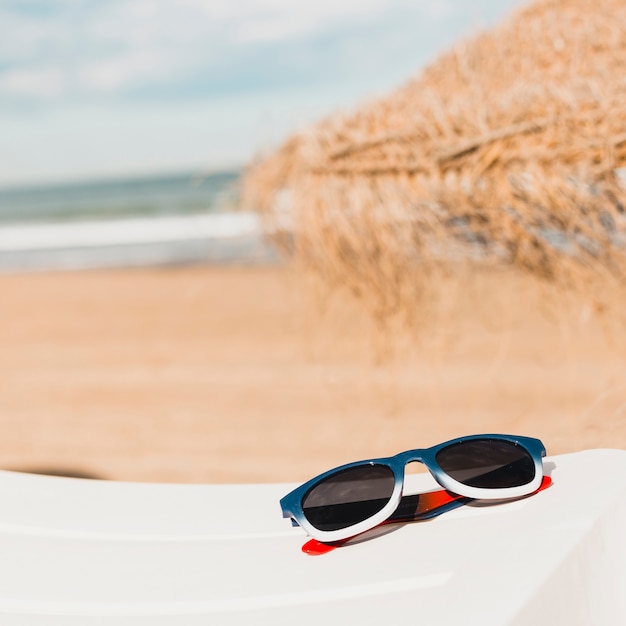 Free photo beach concept with sunglasses on towel