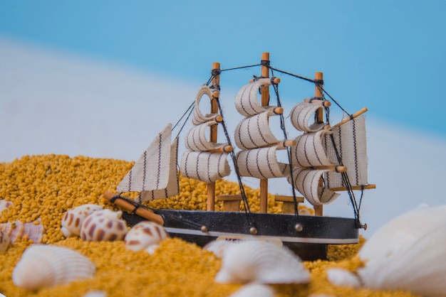 Free photo beach concept with toy sailing boat