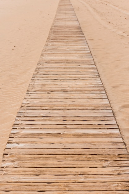 Free photo beach concept with wooden pathway