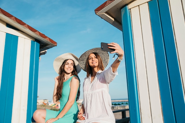 Beach and summer concept with women taking selfie