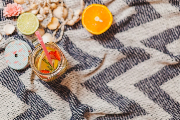 Beach towel with summer drink and orange