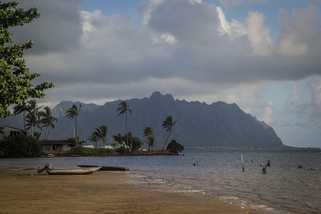 Beach of Waimanalo during misty weather with breathtaking large grey clouds in the sky