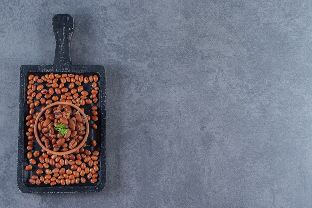 Bean bowl on the bean board , on the blue background.