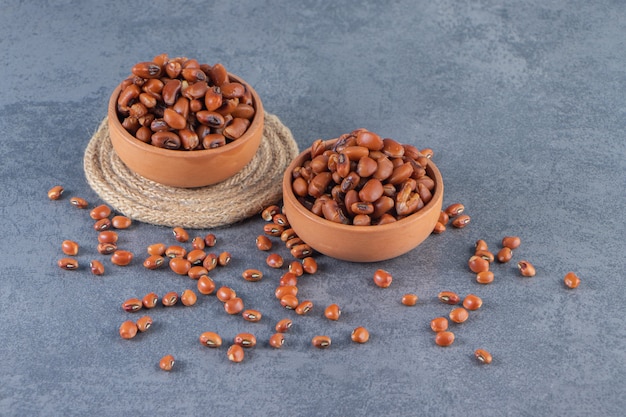 Free photo bean bowls and trivet on the blue surface