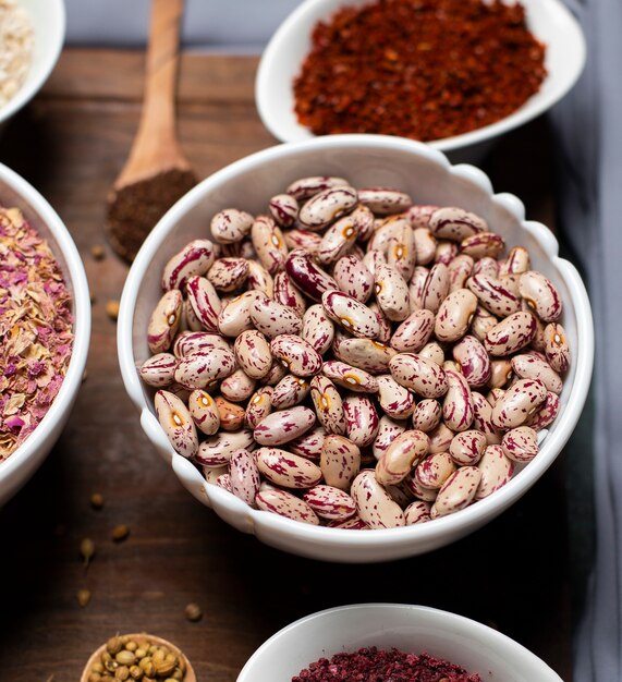 Beans and sumakh in white bowls