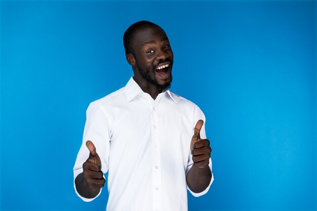 Bearded afroamerican guy with thumbs up is laughing