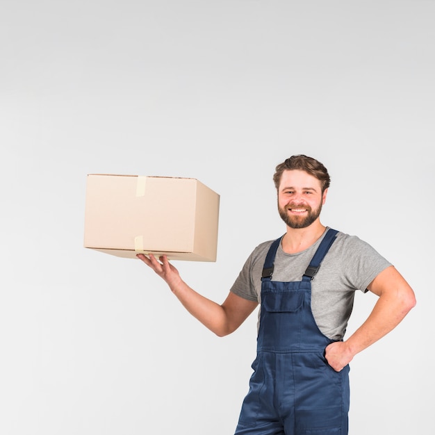 Bearded delivery man holding box