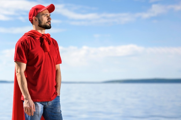 Bearded delivery man wearing superhero cape