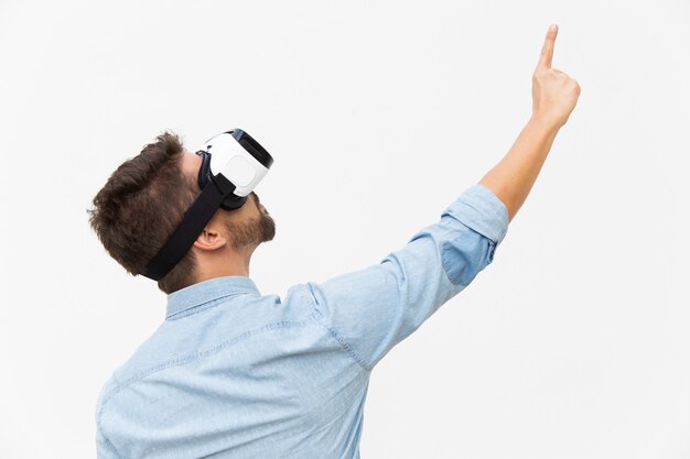 Bearded guy wearing VR goggles, pointing finger up
