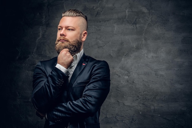 Bearded hipster male in purple suit isolated  on grey vignette background.