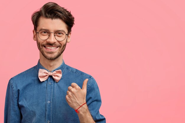 Bearded man in denim shirt and pink bowtie