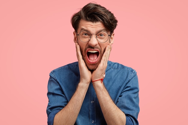 Bearded man in denim shirt and pink bowtie