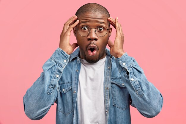 Bearded man in denim shirt and round glasses