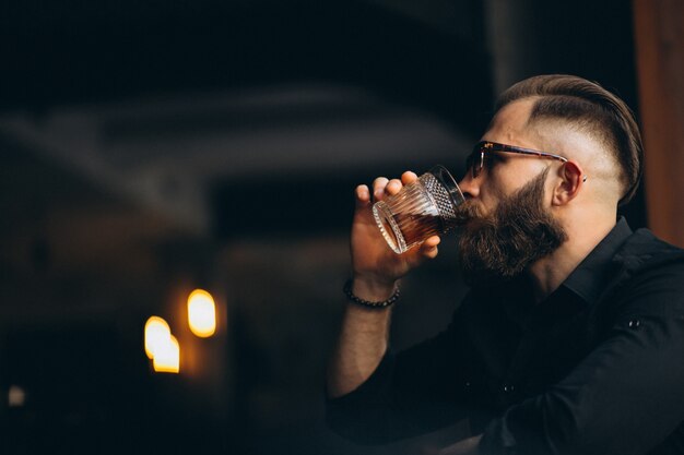 Bearded man drinking in a bar