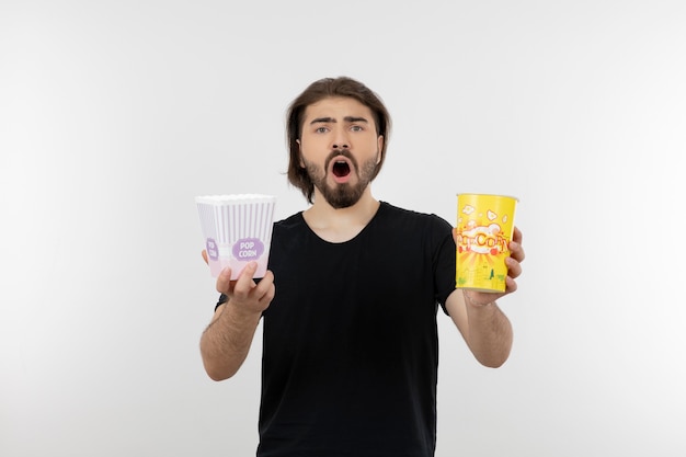 bearded man holding buckets of popcorn.