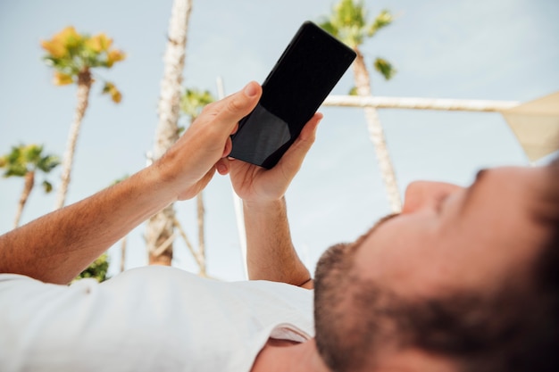 Bearded man holding modern phone