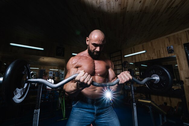 Bearded man lifting barbell during training